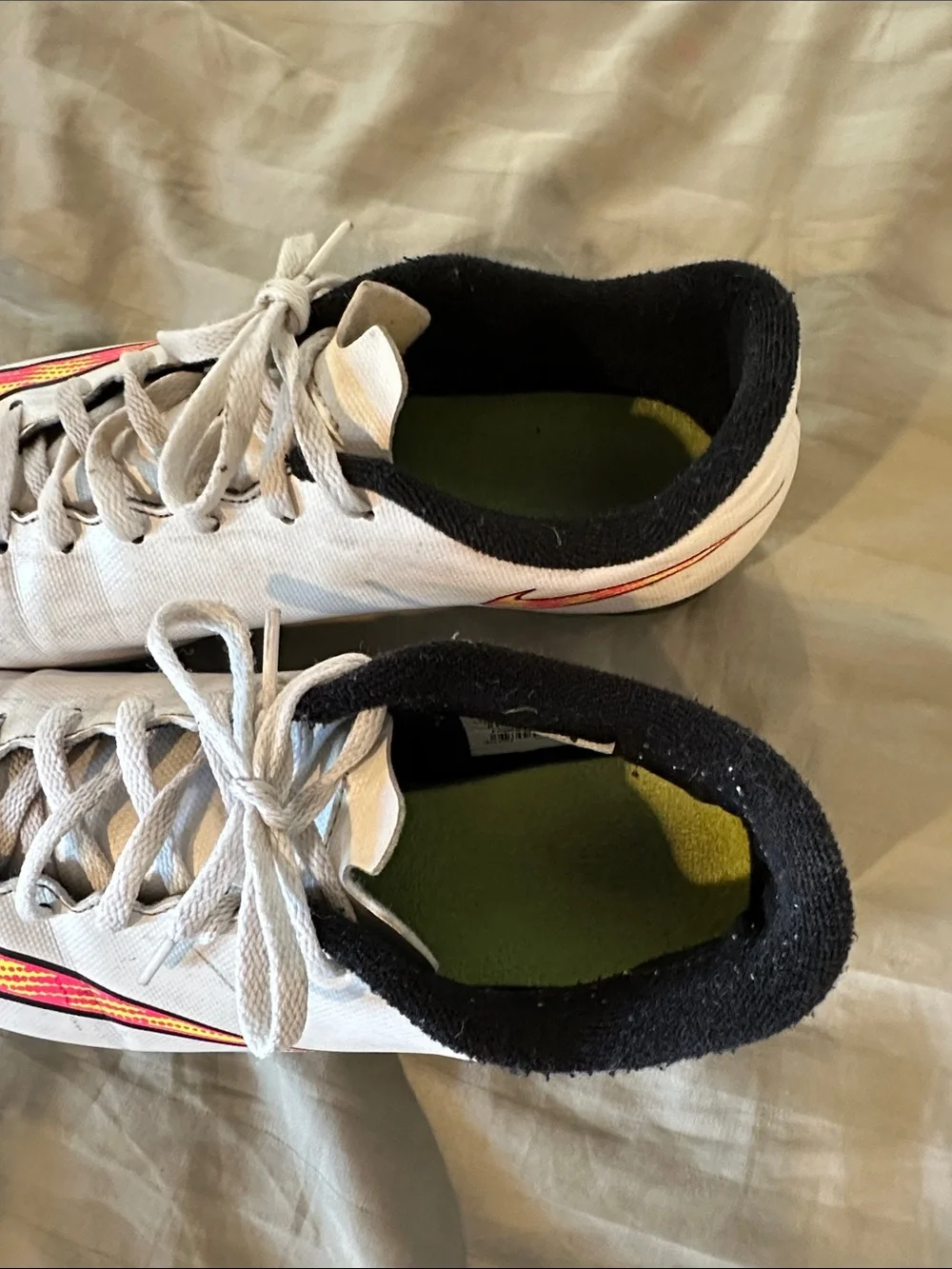 Nike Kids White Soccer Cleats with Neon Yellow and Pink Swoosh